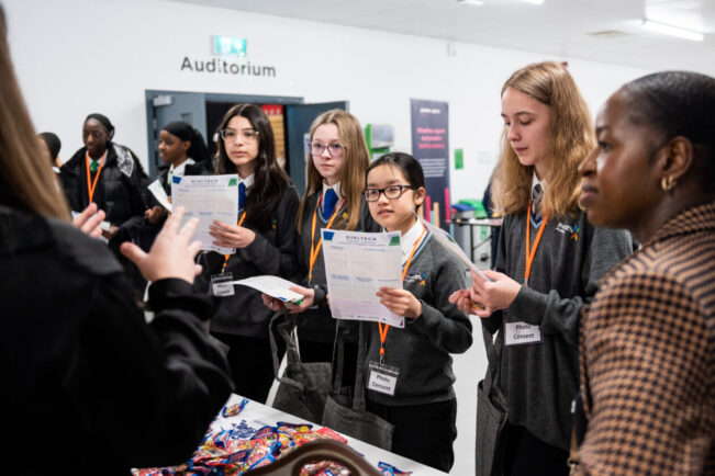 Young women at Girl Tech Leeds event engaged in conversation with professionals from the digital and tech industries